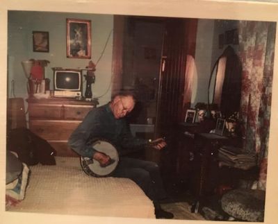 Ervin as older man in room with banjo